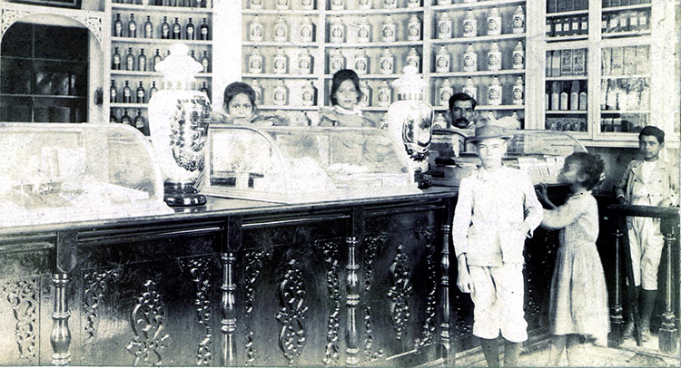 Black and white photograph of the interior of a pharmacy
