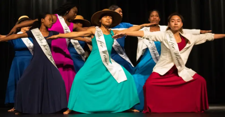 A group of Black dancers in dresses