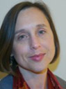 Woman with short brown hair wearing gray blazer and red blouse