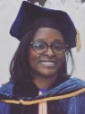 Woman wearing glasses, motar board, and gown